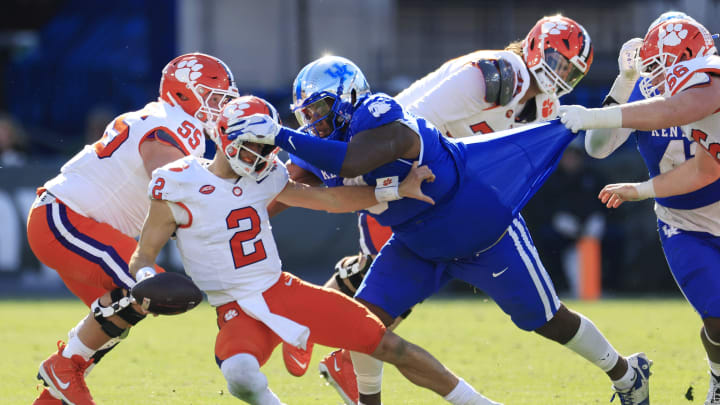 Clemson Tigers quarterback Cade Klubnik (2) is sacked by Kentucky Wildcats defensive lineman Deone Walker (0) during the third quarter of an NCAA football matchup in the TaxSlayer Gator Bowl Friday, Dec. 29, 2023 at EverBank Stadium in Jacksonville, Fla. The Clemson Tigers edged the Kentucky Wildcats 38-35. [Corey Perrine/Florida Times-Union]