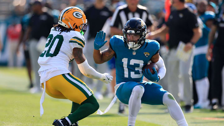 Jacksonville Jaguars wide receiver Christian Kirk (13) tries to manuver past Green Bay Packers safety Javon Bullard (20) during the third quarter of an NFL football matchup Sunday, Oct. 27, 2024 at EverBank Stadium in Jacksonville, Fla. The Packers edged the Jaguars 30-27 on a last-second field goal. [Corey Perrine/Florida Times-Union]