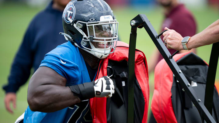 Center Lloyd Cushenberry III hits the sled during drills during the Tennessee Titans mandatory mini-camp at Ascension Saint Thomas Sports Park in Nashville, Tenn., Wednesday, June 5, 2024.