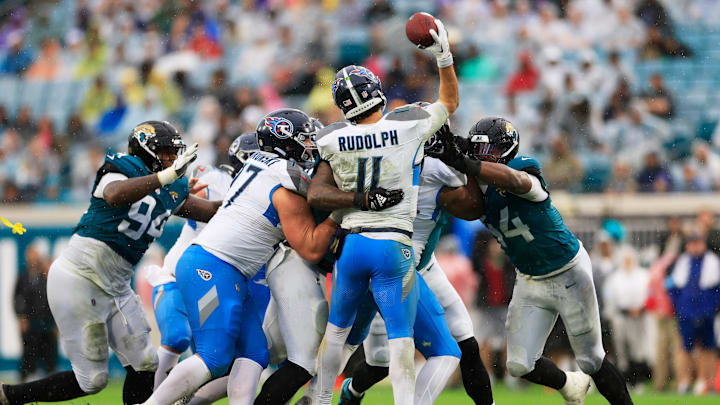 Tennessee Titans quarterback Mason Rudolph (11) is pressured by Jacksonville Jaguars defensive end Travon Walker (44) during the second quarter of an NFL football matchup Sunday, Dec. 29, 2024 at EverBank Stadium in Jacksonville, Fla. [Corey Perrine/Florida Times-Union]