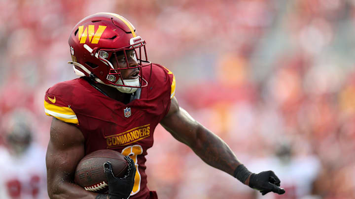 Sep 8, 2024; Tampa, Florida, USA; Washington Commanders running back Brian Robinson Jr. (8) runs with the ball against the Tampa Bay Buccaneers in the third quarter at Raymond James Stadium. Mandatory Credit: Nathan Ray Seebeck-Imagn Images