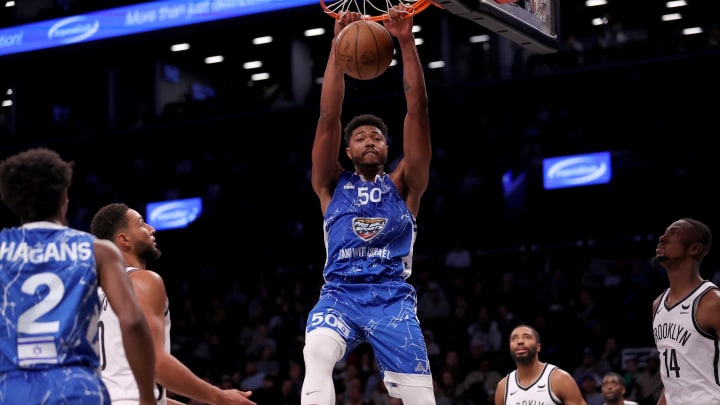 Oct 12, 2023; Brooklyn, NY, USA; Maccabi Ra'anana forward Bruno Caboclo (50) dunks against Brooklyn Nets guard Ben Simmons (10) and forwards Mikal Bridges (1) and Harry Giles III (14) during the second quarter at Barclays Center. Mandatory Credit: Brad Penner-USA TODAY Sports