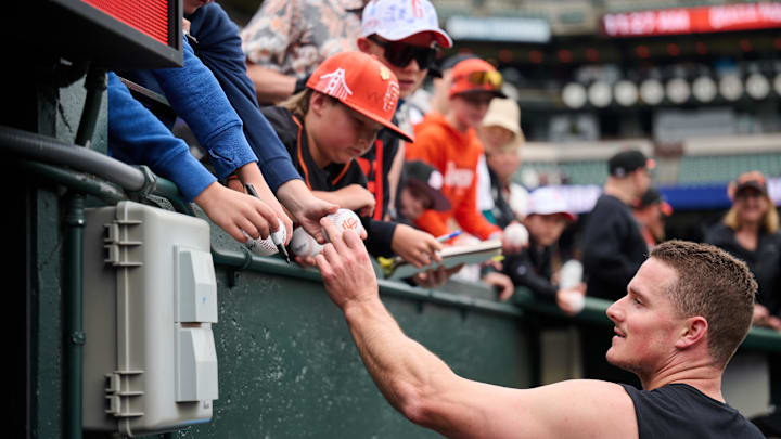 May 12, 2024; San Francisco, California, USA; San Francisco Giants infielder Matt Chapman (26) signs an autograph for a fan before the game between the San Francisco Giants and the Cincinnati Reds at Oracle Park May 12, 2024; San Francisco, California, USA; San Francisco Giants infielder Matt Chapman (26) signs an autograph for a fan before the game between the San Francisco Giants and the Cincinnati Reds at Oracle Park