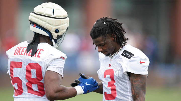 Jul 24, 2024; East Rutherford, NJ, USA; New York Giants cornerback Deonte Banks (3) slaps hand with linebacker Bobby Okereke (58) during training camp at Quest Diagnostics Training Facility.  