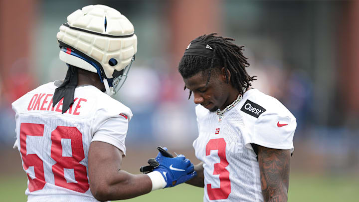 Jul 24, 2024; East Rutherford, NJ, USA; New York Giants cornerback Deonte Banks (3) slaps hand with linebacker Bobby Okereke (58) during Quest Diagnostics Training Facility training camp.  