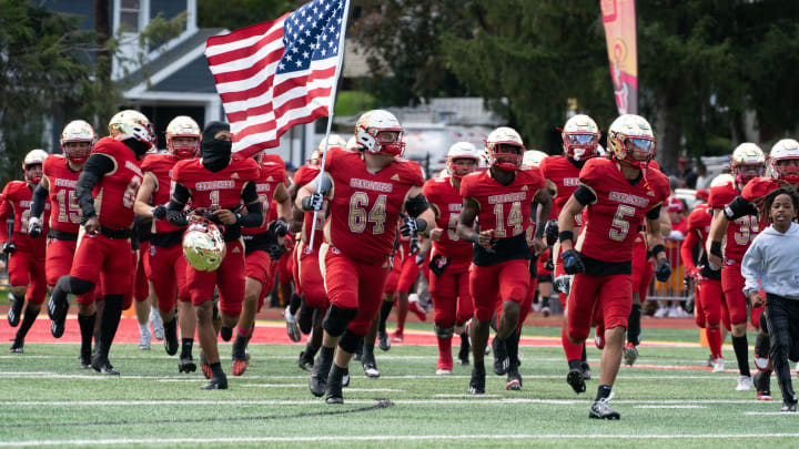 Bergen Catholic runs onto the field before the start of a football game between Bergen Catholic High School and St. Joseph Regional High School at Bergen Catholic High School in Oradell on Sunday, October 15, 2023.