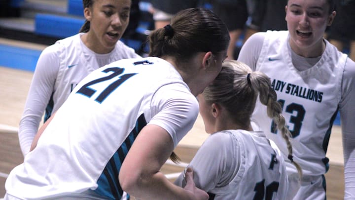 Providence guard Janie Boyd (10) is helped to her feet by teammates Julianna Baskin (21), Janai Jordan (2) and Kennedy Loux (13) after drawing a charge against San Jose Prep during the FHSAA District 3-2A high school girls basketball final on Feb. 8, 2025. [Clayton Freeman/Florida Times-Union]