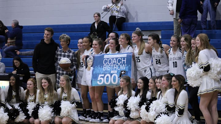Providence girls basketball coach Gigi Bistrow and her team celebrate her 500th career victory after an FHSAA Region 1-3A girls basketball quarterfinal on February 10, 2022. [Clayton Freeman/Florida Times-Union]