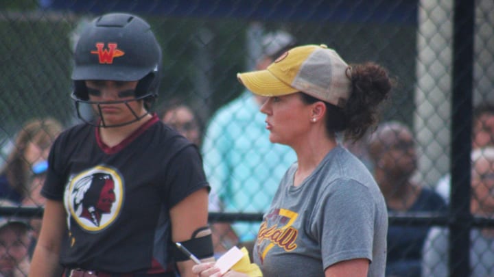 West Nassau head coach Randalyn Bryant comes to the plate to indicate a lineup change during a high school softball game against University Christian on April 2, 2024. [Clayton Freeman/Florida Times-Union]