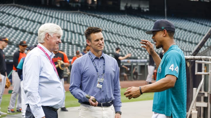 Seattle Mariners center fielder Julio Rodriguez (44) talks with majority owner John Stanton, left, and general manager Jerry Dipoto during batting practice against the Baltimore Orioles at T-Mobile Park in 2023.
