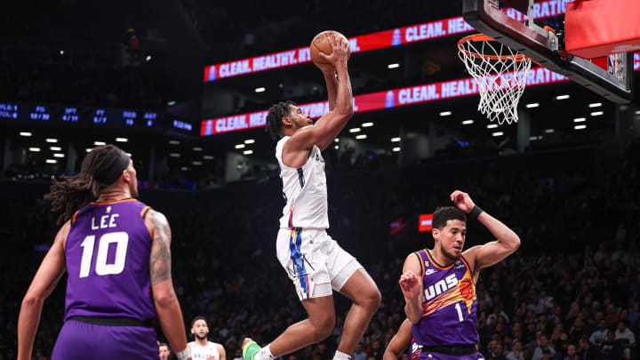 Feb 7, 2023; Brooklyn, New York, USA; Brooklyn Nets guard Cam Thomas (24) drives to the basket in front of  Phoenix Suns guard Devin Booker (1) and guard Damion Lee (10) during the first half at Barclays Center. Mandatory Credit: Vincent Carchietta-USA TODAY Sports