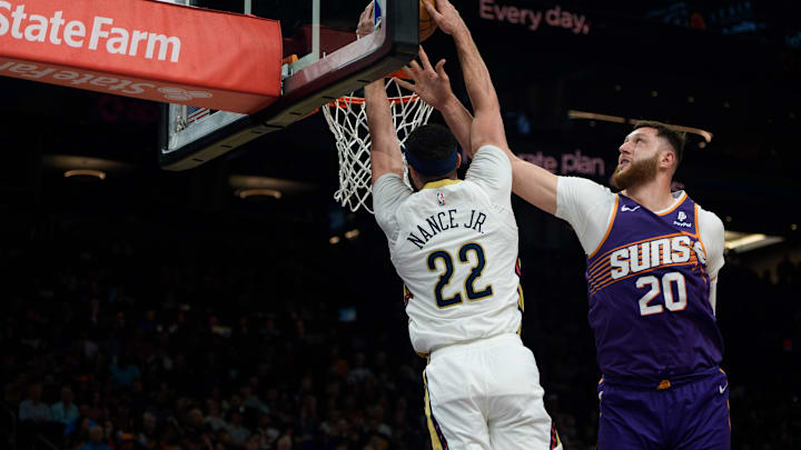 Apr 7, 2024; Phoenix, Arizona, USA;  New Orleans Pelicans forward-center Larry Nance Jr. (22) dunks over Phoenix Suns center Jusuf Nurkic (20) during the first half at Footprint Center. Mandatory Credit: Allan Henry-Imagn Images