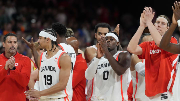 Aug 2, 2024; Villeneuve-d'Ascq, France; Canada point guard Andrew Nembhard (19) and guard Luguentz Dort (0) and forward Kelly Olynyk (13) celebrate with teammates after defeating Spain in a men’s group A basketball game during the Paris 2024 Olympic Summer Games at Stade Pierre-Mauroy. Mandatory Credit: John David Mercer-USA TODAY Sports