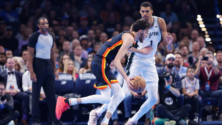 Nov 14, 2023; Oklahoma City, Oklahoma, USA; Oklahoma City Thunder forward Chet Holmgren (7) drives past San Antonio Spurs center Victor Wembanyama (1) during the second quarter at Paycom Center. Mandatory Credit: Alonzo Adams-USA TODAY Sports