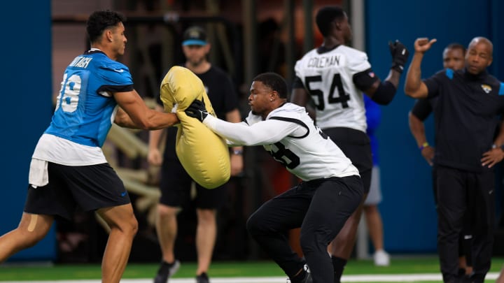 Jacksonville Jaguars linebacker Andrew Parker Jr. (58) hits a pad against tight end Patrick Murtagh (88) during the second day of a mandatory minicamp Tuesday, June 11, 2024 at EverBank Stadium’s Miller Electric Center in Jacksonville, Fla. [Corey Perrine/Florida Times-Union]
