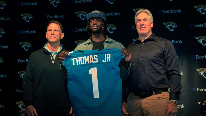 Jacksonville Jaguars wide receiver Brian Thomas Jr. (1), center, holds up his new jersey next to general manager Trent Baalke, left, and head coach Doug Pederson during a press conference Friday, April 26, 2024 at EverBank Stadium’s Miller Electric Center in Jacksonville, Fla. Jacksonville Jaguars selected LSU’s wide receiver Thomas Jr. as the 23rd overall pick in last night’s NFL Draft. [Corey Perrine/Florida Times-Union]