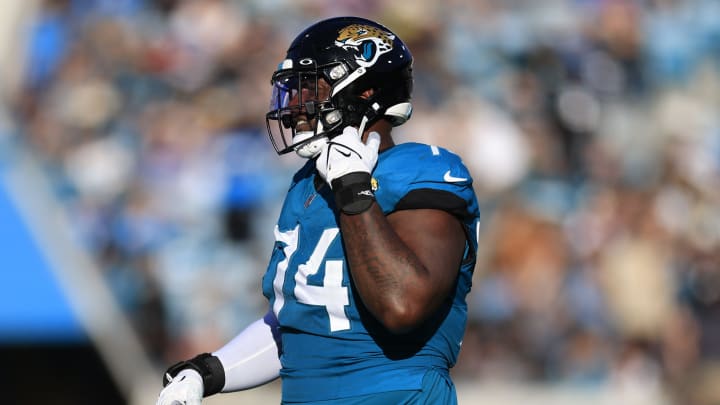 Jacksonville Jaguars offensive tackle Cam Robinson (74) walks off the field after being ejected for fighting with Carolina Panthers defensive tackle Derrick Brown (95), not shown, during the fourth quarter of a regular season NFL football matchup Sunday, Dec. 31, 2023 at EverBank Stadium in Jacksonville, Fla. The Jacksonville Jaguars blanked the Carolina Panthers 26-0. [Corey Perrine/Florida Times-Union]