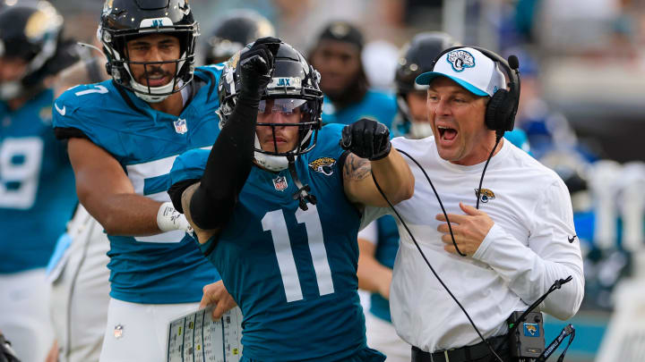 Jacksonville Jaguars wide receiver Parker Washington (11) celebrates his catch and run with special teams coordinator Heath Farwell during the first quarter of a preseason NFL football game Saturday, Aug. 10, 2024 at EverBank Stadium in Jacksonville, Fla. [Corey Perrine/Florida Times-Union]