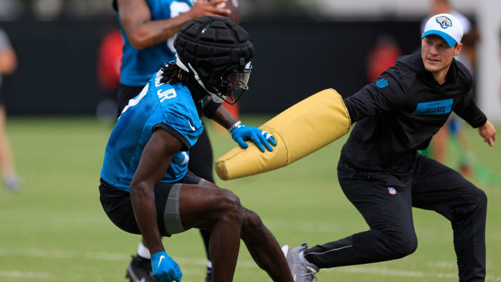 Jacksonville Jaguars wide receiver Brian Thomas Jr. (7) is pressured by assistant wide receivers coach, passing game specialist Tyler Tettleton during a combined NFL football training camp session between the Tampa Bay Buccaneers and Jacksonville Jaguars Thursday, Aug. 15, 2024 at EverBank Stadium’s Miller Electric Center in Jacksonville, Fla. [Corey Perrine/Florida Times-Union]