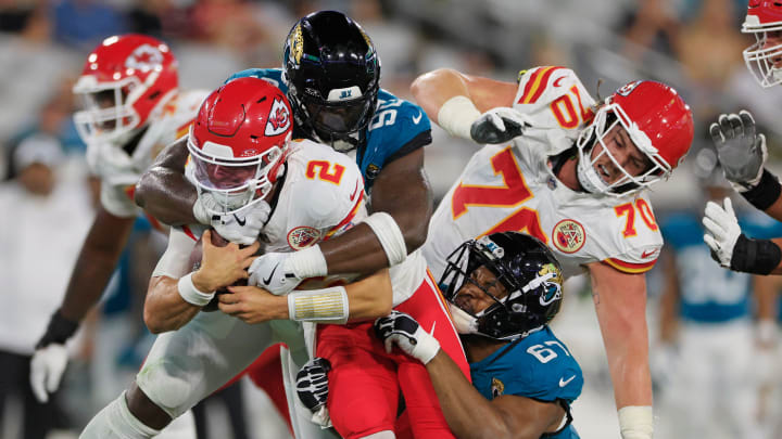 Jacksonville Jaguars defensive tackle Esezi Otomewo (90) and defensive end Breeland Speaks (67) tackle Kansas City Chiefs quarterback Ian Book (2) during the fourth quarter of a preseason NFL football game Saturday, Aug. 10, 2024 at EverBank Stadium in Jacksonville, Fla. The Jacksonville Jaguars defeated the Kansas City Chiefs 26-13. [Corey Perrine/Florida Times-Union]