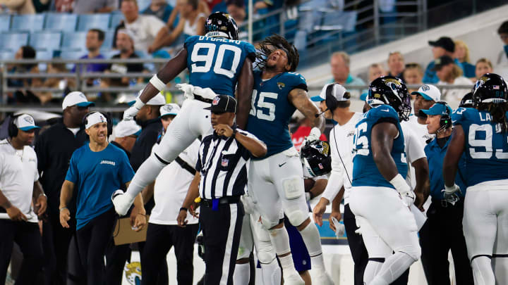 Jacksonville Jaguars defensive end Esezi Otomewo (90) and defensive end Roy Robertson-Harris (95) celebrate a defensive stop during the third quarter of a preseason NFL football game Saturday, Aug. 10, 2024 at EverBank Stadium in Jacksonville, Fla. The Jacksonville Jaguars defeated the Kansas City Chiefs 26-13. [Corey Perrine/Florida Times-Union]