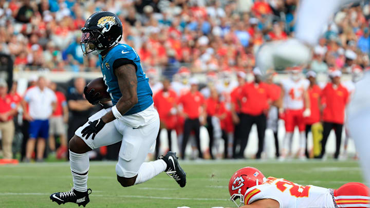 Jacksonville Jaguars running back Travis Etienne Jr. (1) escapes Kansas City Chiefs linebacker Drue Tranquill (23) during the first quarter of a preseason NFL football game Saturday, Aug. 10, 2024 at EverBank Stadium in Jacksonville, Fla. [Corey Perrine/Florida Times-Union]