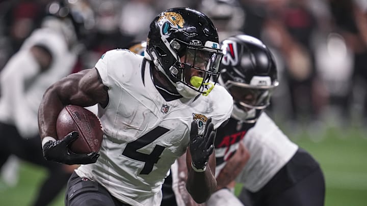 Aug 23, 2024; Atlanta, Georgia, USA; Jacksonville Jaguars running back Tank Bigsby (4) runs with the ball against the Atlanta Falcons during the first half at Mercedes-Benz Stadium. Mandatory Credit: Dale Zanine-Imagn Images