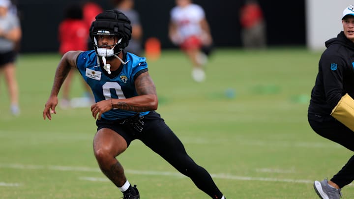 Jacksonville Jaguars wide receiver Gabe Davis (0) runs as assistant wide receivers coach, passing game specialist Tyler Tettleton looks on during a combined NFL football training camp session between the Tampa Bay Buccaneers and Jacksonville Jaguars Thursday, Aug. 15, 2024 at EverBank StadiumÕs Miller Electric Center in Jacksonville, Fla. [Corey Perrine/Florida Times-Union]