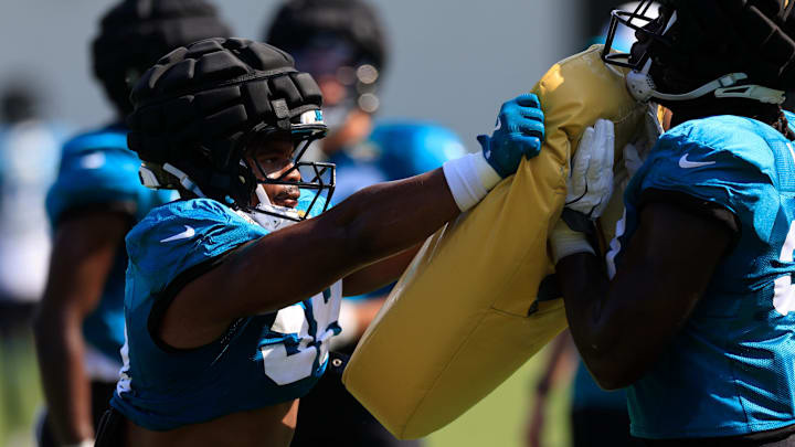 Jacksonville Jaguars linebacker Andrew Parker Jr. (58) drills on a blocking pad with linebacker Devin Lloyd (33) during a combined NFL football training camp session between the Tampa Bay Buccaneers and Jacksonville Jaguars Wednesday, Aug. 14, 2024 at EverBank Stadium’s Miller Electric Center in Jacksonville, Fla. [Corey Perrine/Florida Times-Union]