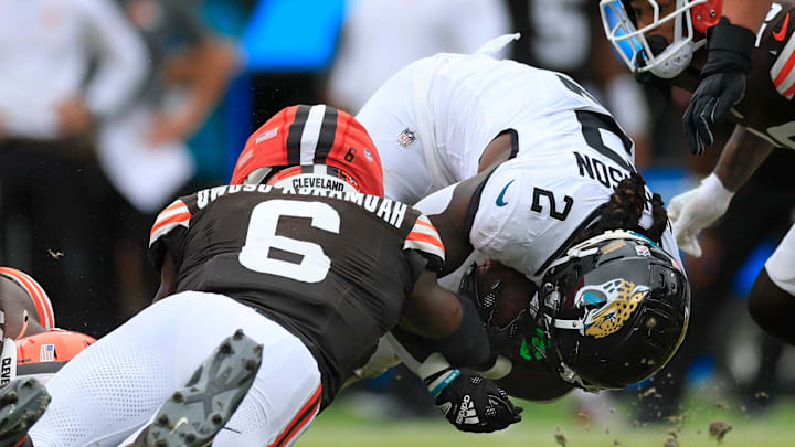 Jacksonville Jaguars running back D'Ernest Johnson (2) is tackled by Cleveland Browns linebacker Jeremiah Owusu-Koramoah (6) during the third quarter of an NFL football matchup Sunday, Sept. 15, 2024 at EverBank Stadium in Jacksonville, Fla. The Browns defeated the Jaguars 18-13. [Corey Perrine/Florida Times-Union]