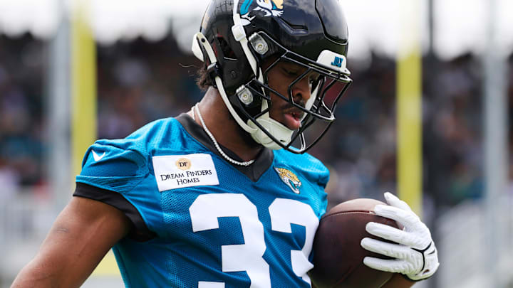 Jacksonville Jaguars running back Bhayshul Tuten (33) runs the ball during a rookie minicamp at Miller Electric Center Saturday, May 10, 2025 in Jacksonville, Fla. [Corey Perrine/Florida Times-Union]
