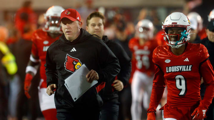 Louisville's Jeff Brohm comes out onto the field against Notre Dame at L&N Stadium.