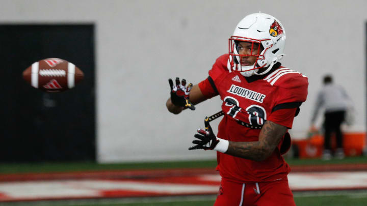 Louisville’s Tayon Holloway (20) catches the ball during Spring Practice on Thursday.