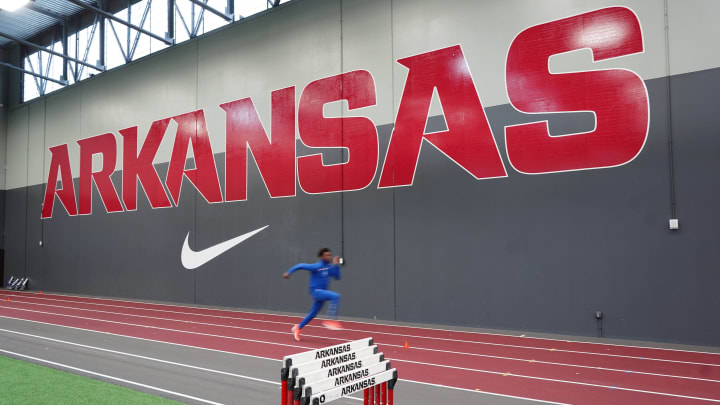 Mar 13, 2021; Fayetteville, Arkansas, USA; Malcolm Clemons of Florida warms up for the triple jump with the Arkansas Razorbacks and Nike swoosh logos as a backdrop during the NCAA Indoor Track and Field Championships at the Randal Tyson Center.