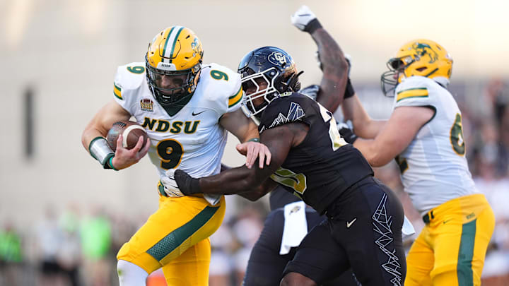 Aug 29, 2024; Boulder, Colorado, USA; Colorado Buffaloes linebacker LaVonta Bentley (20) tackles North Dakota State Bison quarterback Cole Payton (9) in the first half at Folsom Field. Mandatory Credit: Ron Chenoy-Imagn Images