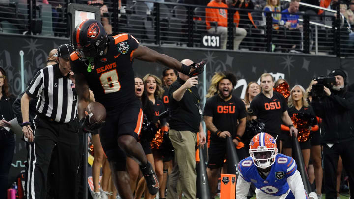 Dec 17, 2022; Las Vegas, NV, USA; Oregon State Beavers running back Jam Griffin (8) scores a touchdown against Florida Gators wide receiver Ja   Quavion Fraziars (0) during the second half against the Florida Gators at the Las Vegas Bowl at Allegiant Stadium. Mandatory Credit: Lucas Peltier-USA TODAY Sports