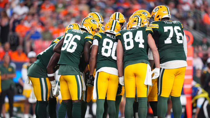 The Green Bay Packers huddle on offense against the Denver Broncos.