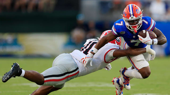 Georgia's Jamon Dumas-Johnson tackling Florida's Trevor Etienne in 2023.