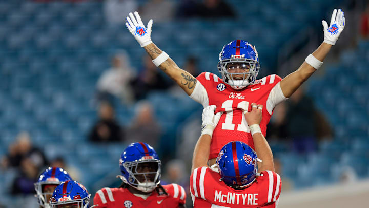 Mississippi Rebels wide receiver Jordan Watkins (11) is hoisted up by offensive lineman Reece McIntyre (56) for his touchdown score during the fourth quarter of the TaxSlayer Gator Bowl Thursday, Jan. 2, 2025 at EverBank Stadium in Jacksonville, Fla. Ole Miss defeated Duke 52-20. [Corey Perrine/Florida Times-Union]