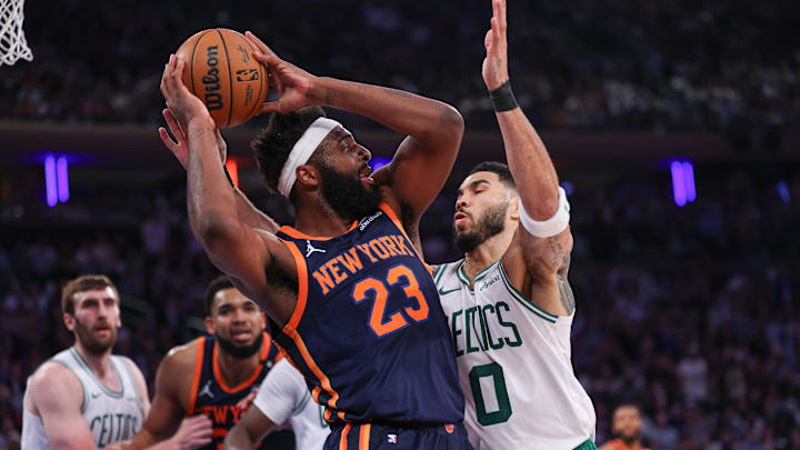 May 12, 2025; New York, New York, USA; New York Knicks center Mitchell Robinson (23) looks to pass after a rebound as Boston Celtics forward Jayson Tatum (0) defends in the first half during game four of the second round for the 2025 NBA Playoffs at Madison Square Garden. Mandatory Credit: Vincent Carchietta-Imagn Images
