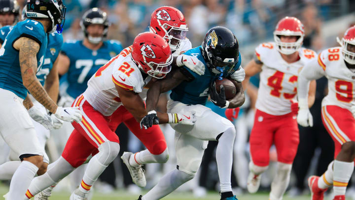 Jacksonville Jaguars running back Tank Bigsby (4) rushes for yards against Kansas City Chiefs safety Jaden Hicks (21) and cornerback Joshua Williams (2) during the first quarter of a preseason NFL football game Saturday, Aug. 10, 2024 at EverBank Stadium in Jacksonville, Fla. [Corey Perrine/Florida Times-Union]