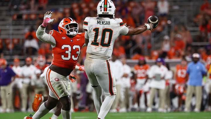 Oct 3, 2026; Clemson, South Carolina, USA; Clemson Tigers defensive lineman Caden Story (33) pressures Miami Hurricanes Quarterback Darian Mensah (10) during the fourth quarter at Memorial Stadium. Mandatory Credit: Ashley Tumlin-Imagn Images