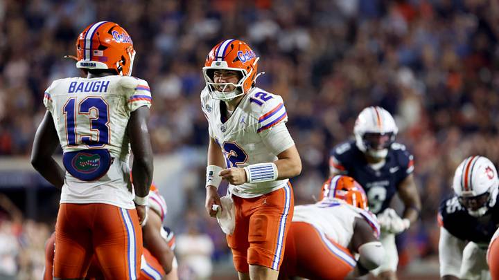 Sep 19, 2026; Auburn, Alabama, USA;  Florida Gators quarterback Aaron Philo (12) talks with running back Jadan Baugh (13) during the third quarter against the Auburn Tigers at Jordan-Hare Stadium.  Mandatory Credit: John Reed-Imagn Images