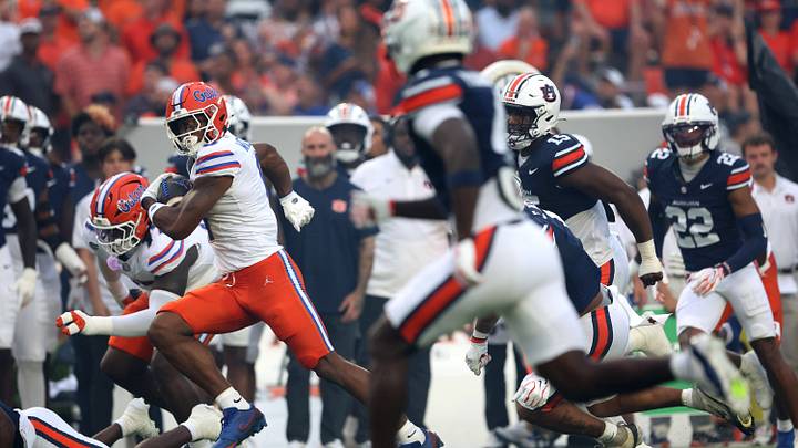 Sep 19, 2026; Auburn, Alabama, USA;  Florida Gators wide receiver Dallas Wilson (6) runs against Auburn Tigers defenders during the first quarter at Jordan-Hare Stadium.  Mandatory Credit: John Reed-Imagn Images
