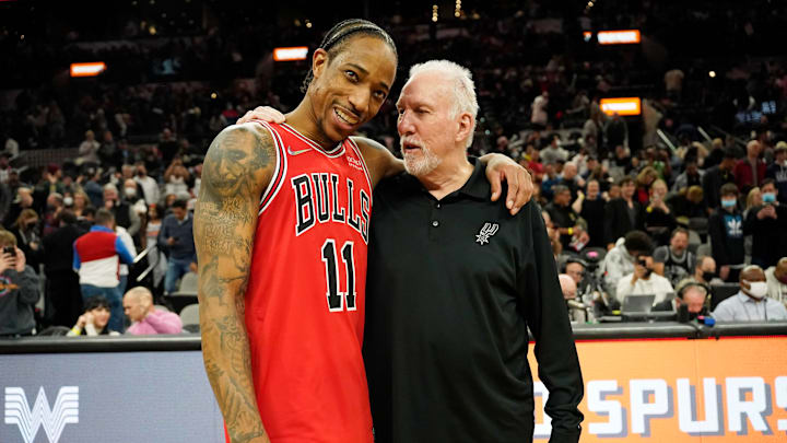 Jan 28, 2022; San Antonio, Texas, USA; Chicago Bulls guard DeMar DeRozan (11) hugs San Antonio Spurs head coach Gregg Popovich after the game at AT&T Center. 