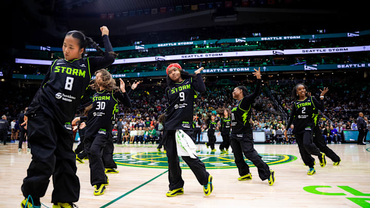 The Seattle Storm Guard Erica Wheeler demonstrates her commitment to community engagement by gifting AE1 sneakers to the Storm Dance Troupe. This act highlights her dedication to supporting local groups and fostering a sense of community through her generosity.
