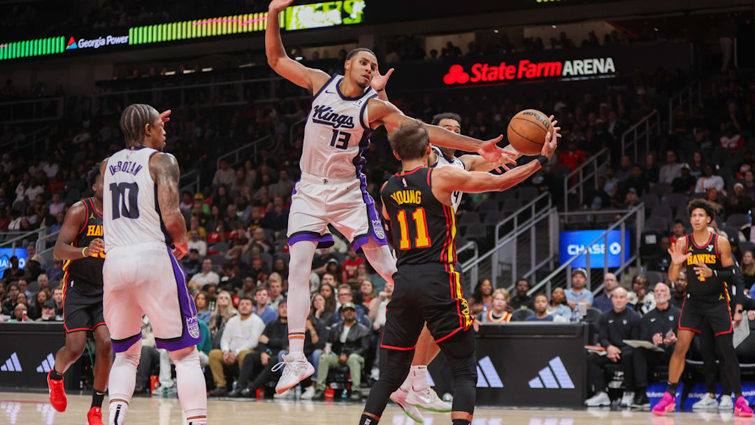 Nov 1, 2024; Atlanta, Georgia, USA; Sacramento Kings forward Keegan Murray (13) defends Atlanta Hawks guard Trae Young (11) in the fourth quarter at State Farm Arena. Mandatory Credit: Brett Davis-Imagn Images