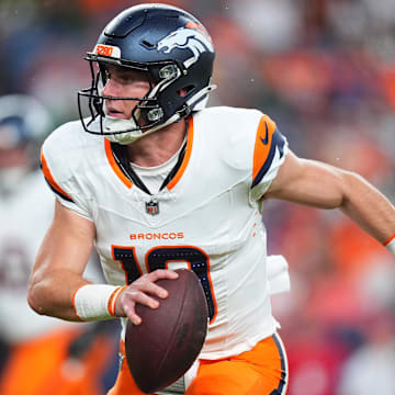 Aug 18, 2024; Denver, Colorado, USA; Denver Broncos quarterback Bo Nix (10) scrambles with the ball in the first quarter against the Green Bay Packers at Empower Field at Mile High. 