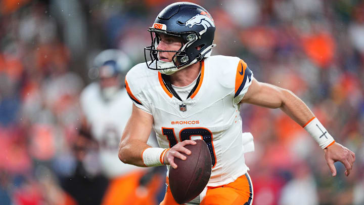 Aug 18, 2024; Denver, Colorado, USA; Denver Broncos quarterback Bo Nix (10) scrambles with the ball in the first quarter against the Green Bay Packers at Empower Field at Mile High. 