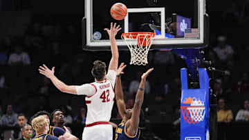 Mar 12, 2025; Charlotte, NC, USA; Stanford Cardinal forward Maxime Raynaud (42) shoots a jumper over California Golden Bears center Mady Sissoko (12) during the first half at Spectrum Center. Mandatory Credit: Jim Dedmon-Imagn Images
